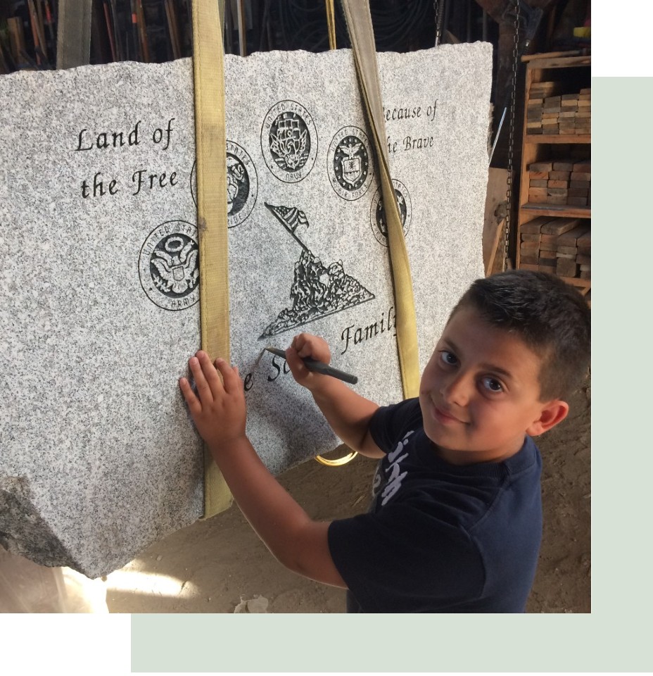 Child works on monument to honor veterans
